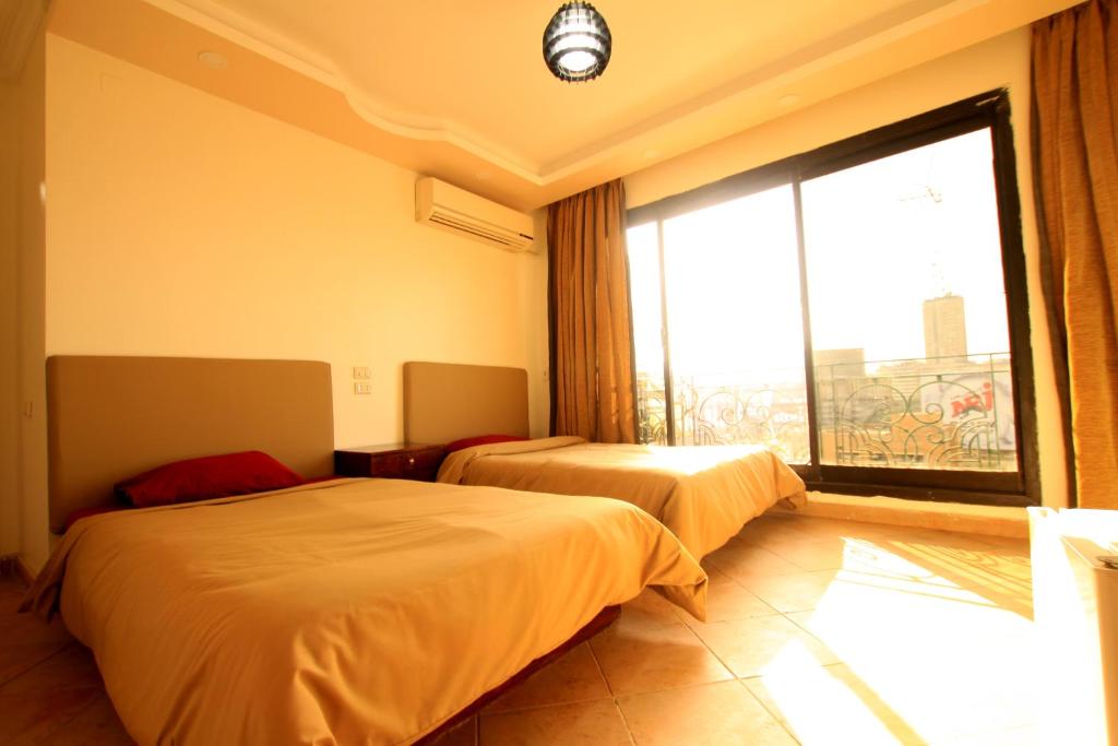 Postel nebo postele na pokoji v ubytování Arabesque Hotel