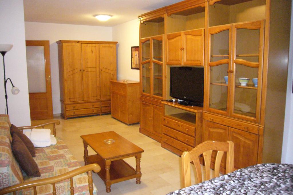 a living room with a large wooden entertainment center at Kennedy 2 - Fincas Arena in Benidorm