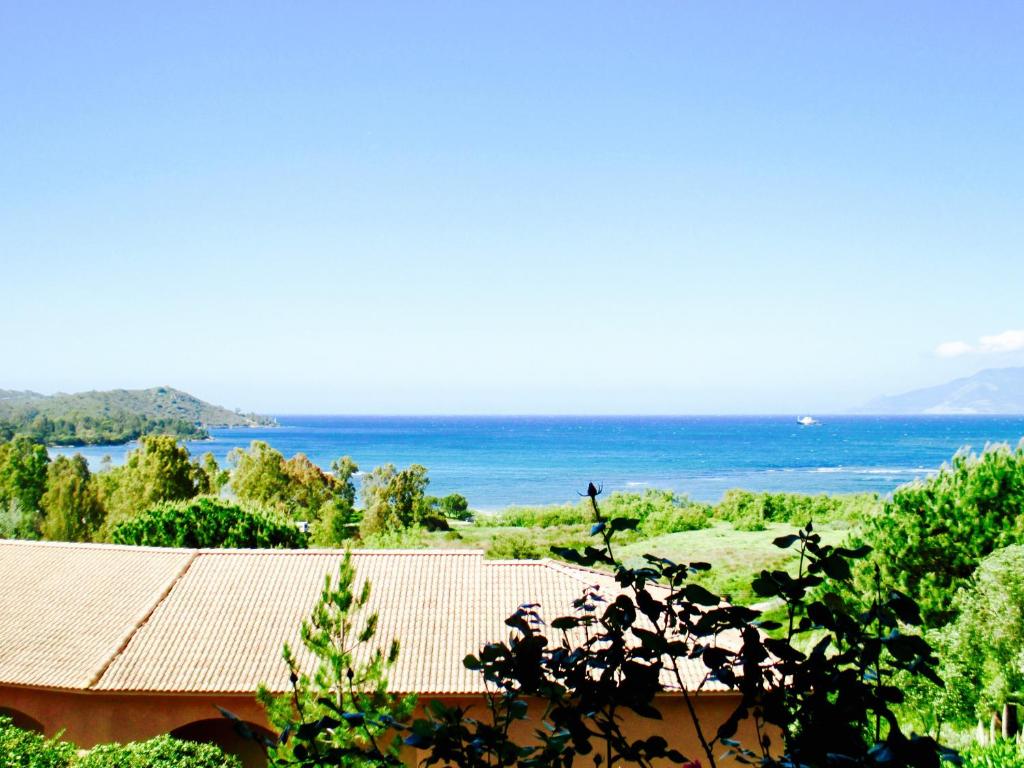 a view of a house with the ocean in the background at Residence Suarella in Saint-Florent