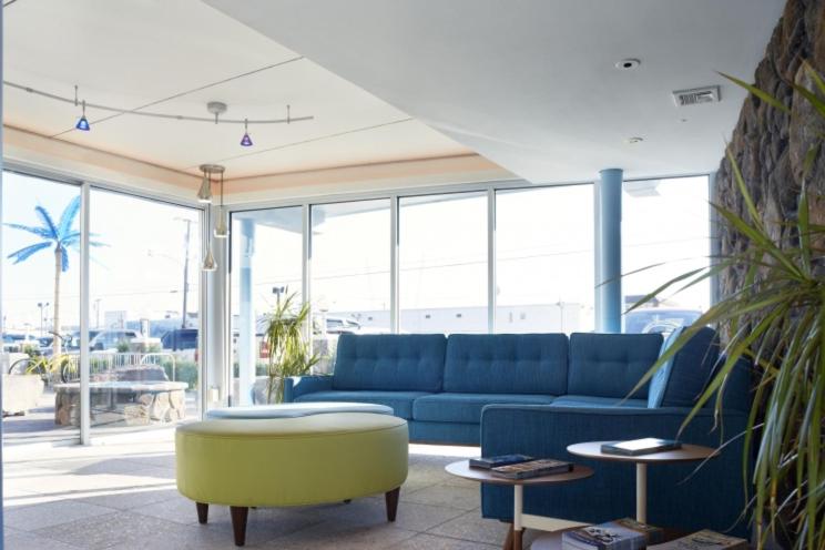 a living room with a blue couch and a table at Blue Palms Resort in Wildwood