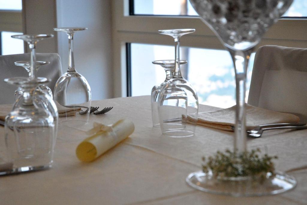 a table with wine glasses on top of it at Hotel Villa Fiorita in Sorrento