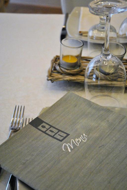 a table with a napkin and a glass of wine at Hotel Villa Fiorita in Sorrento