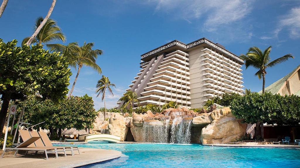 un complexe avec un toboggan et un hôtel dans l'établissement Princess Mundo Imperial Riviera Diamante Acapulco, à Acapulco