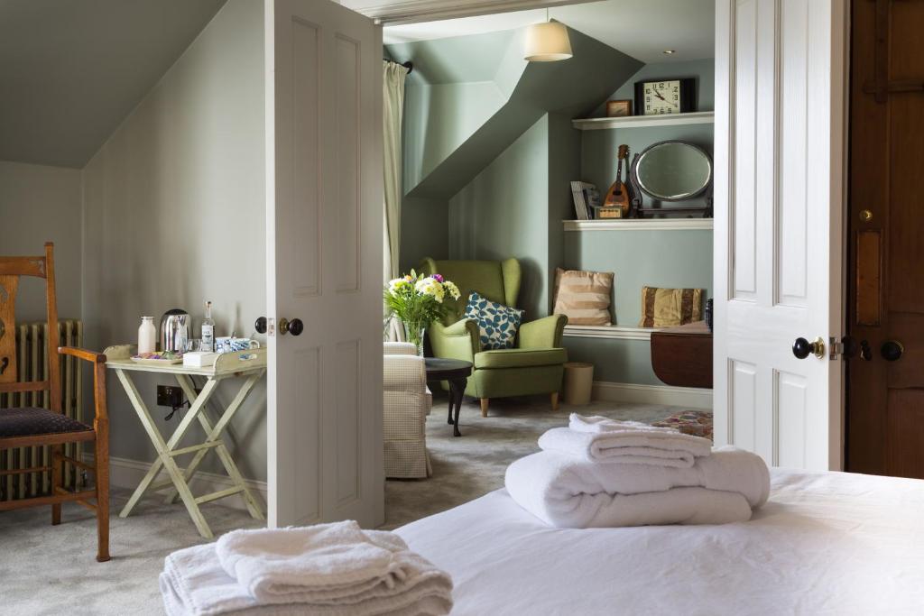 a bedroom with a bed and a living room at Cruickshanks Boutique B&B in Whiting Bay