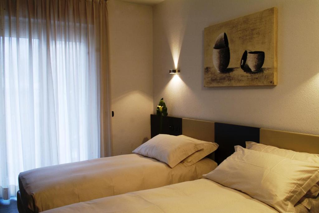 Postel nebo postele na pokoji v ubytování Hotel San Lorenzo Chiavenna