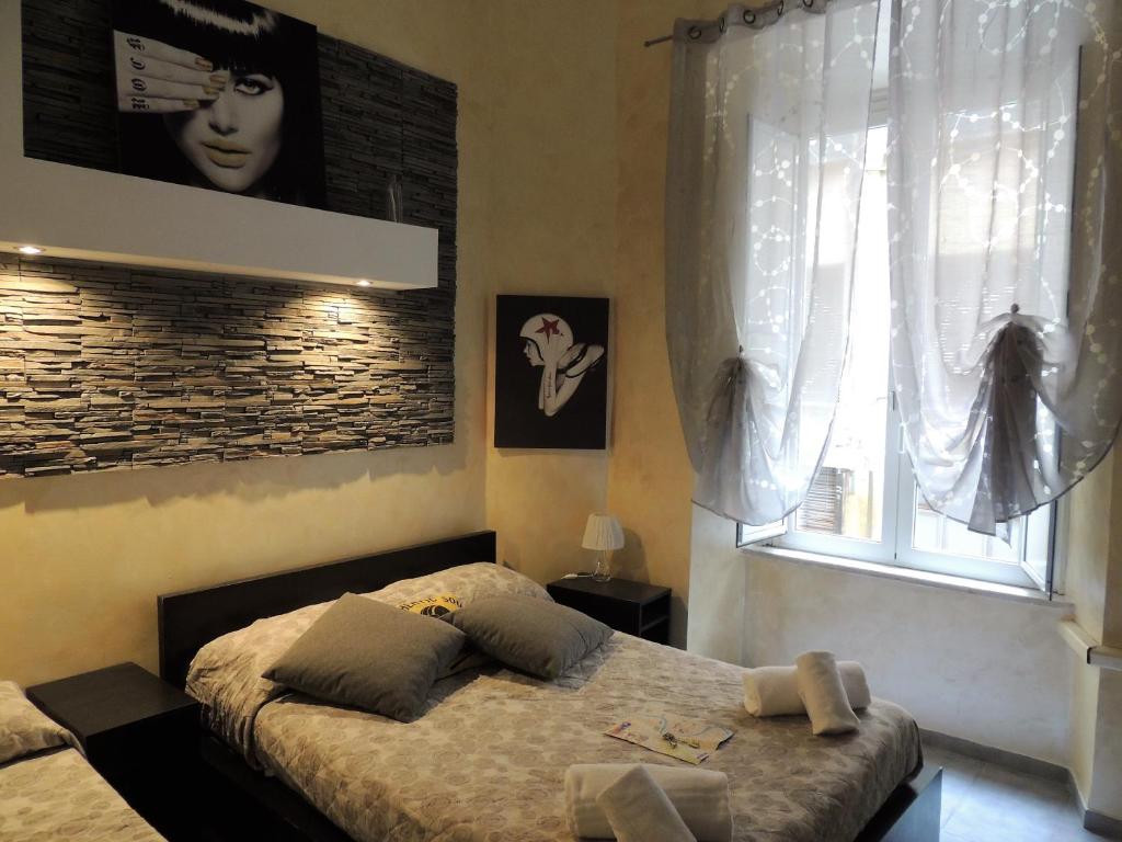 a bedroom with a bed and a window at Double B Ferruccio I in Rome