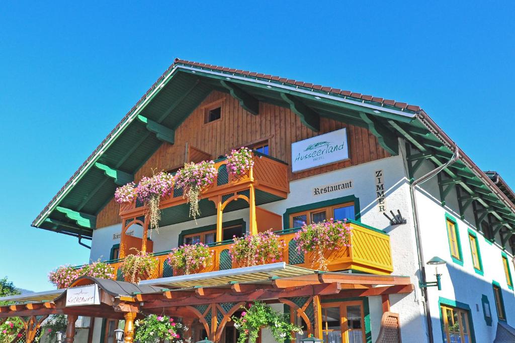 a building with flower boxes on the side of it at Hotel Ausseerland in Bad Mitterndorf