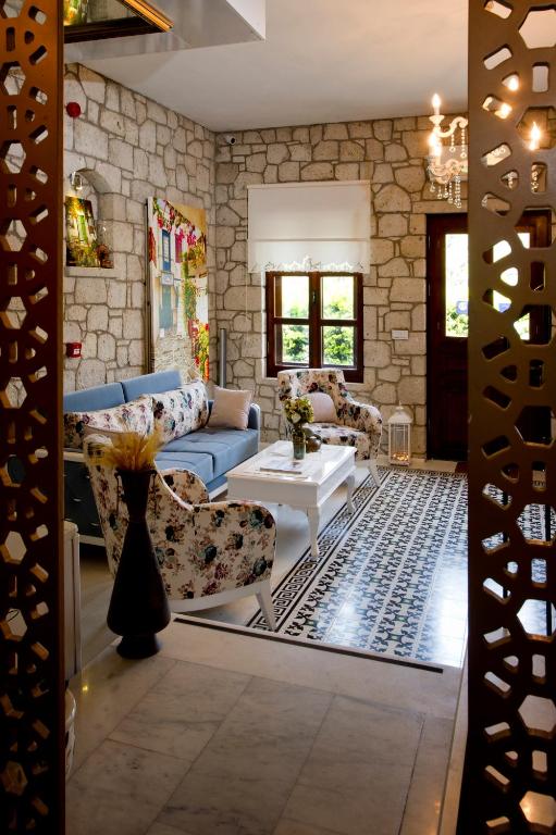 a living room with two couches and a table at Lodos Butik Hotel in Alaçatı