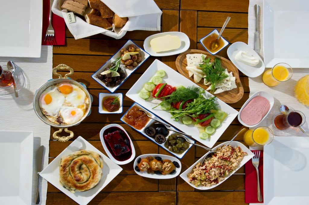 a table with many plates of food on it at Lodos Butik Hotel in Alaçatı