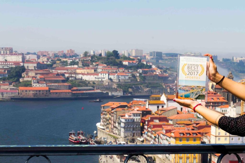 a woman standing on top of a tower looking at a city at Liiiving in Porto | Oporto Garden Pool House in Porto