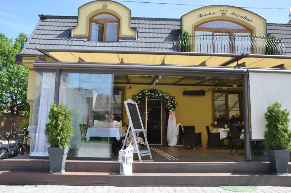 a store front with a window with a dress in it at Penzion Rosenthal in Ružindol