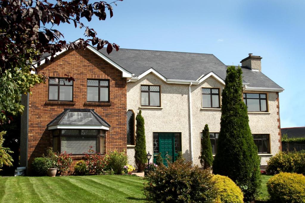 a brick house with a green door at Doogarry House B&B in Castlebar