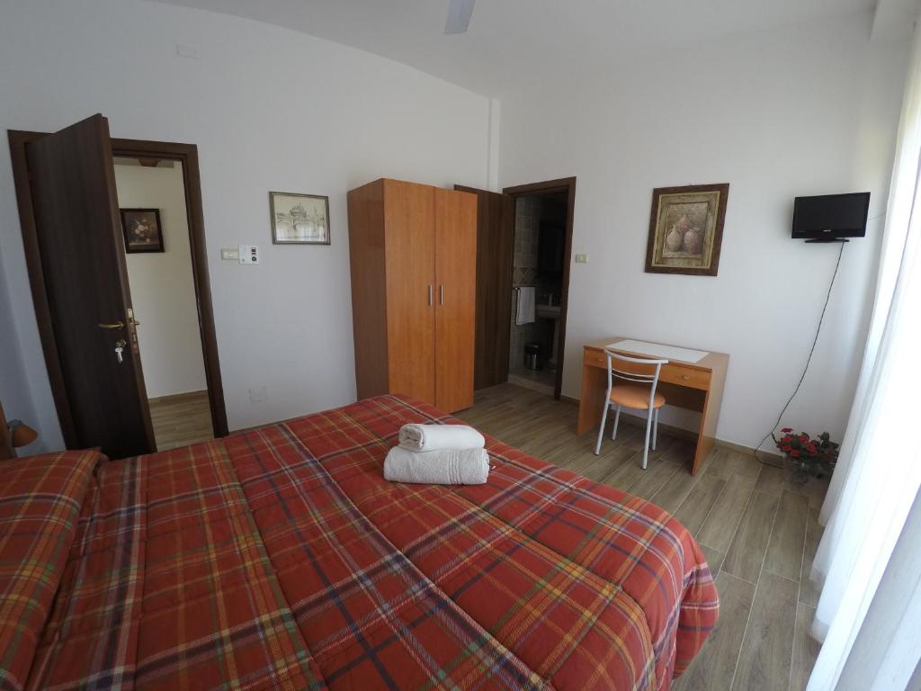 Postel nebo postele na pokoji v ubytování Punta Di Mola