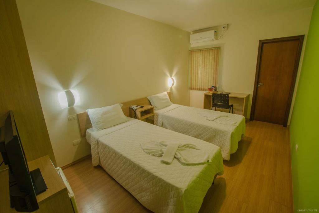 Postel nebo postele na pokoji v ubytování Hotel Dom Thomaz
