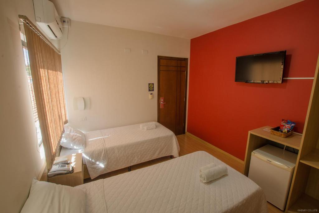 Postel nebo postele na pokoji v ubytování Hotel Dom Thomaz