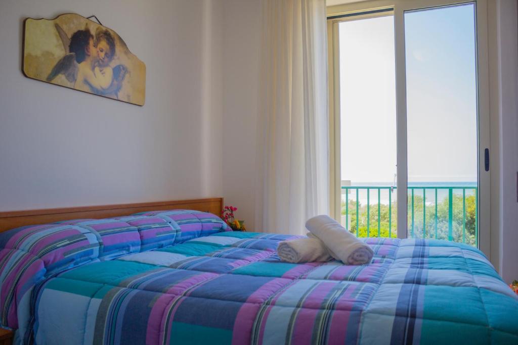 Postel nebo postele na pokoji v ubytování Punta Di Mola