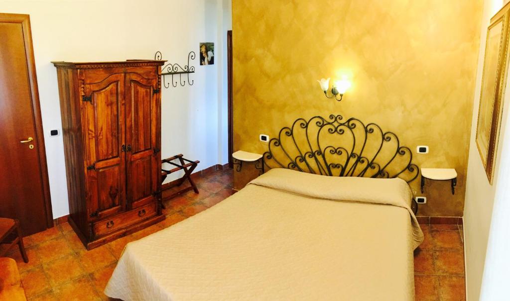Postel nebo postele na pokoji v ubytování Locanda dell'Arcangelo