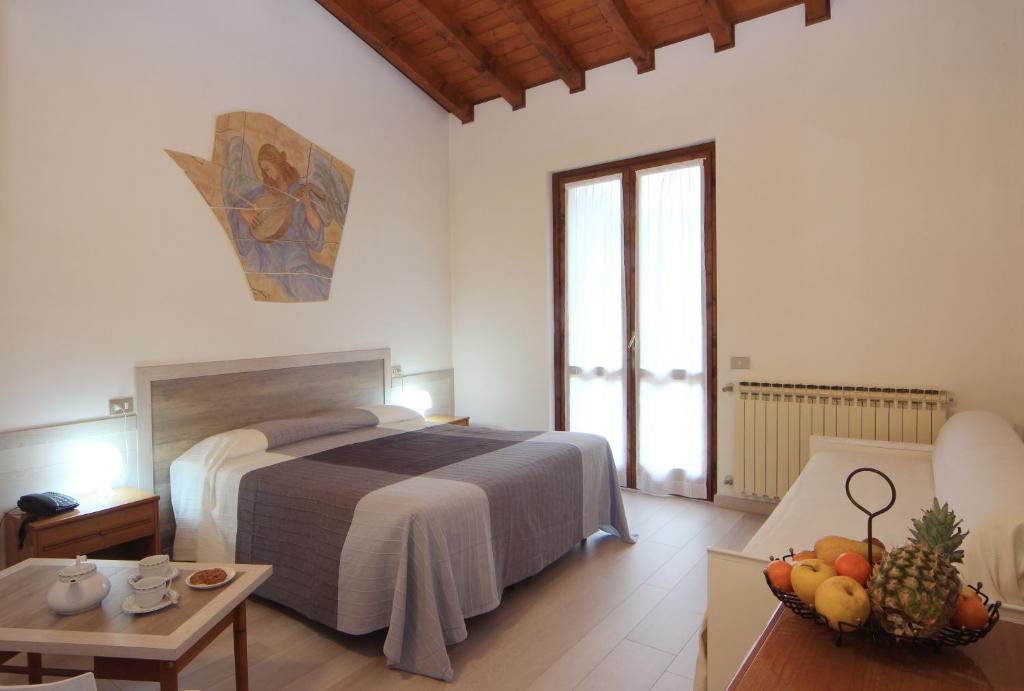 Postel nebo postele na pokoji v ubytování Hotel Colomber