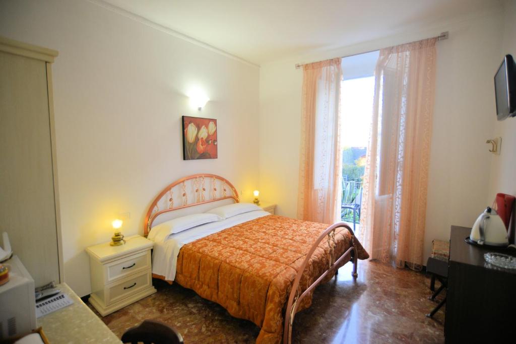 a bedroom with a bed and a large window at Affittacamere Agata in Levanto
