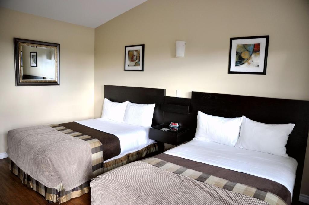 Postel nebo postele na pokoji v ubytování Motel des Cèdres