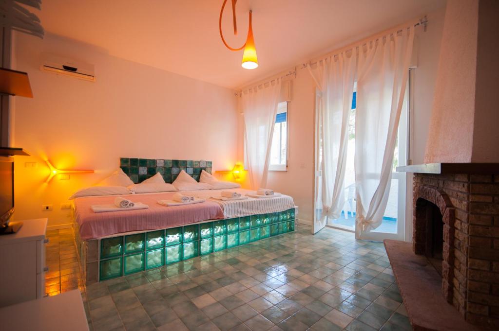 Postel nebo postele na pokoji v ubytování Suite House L'Isola Che Non C'è