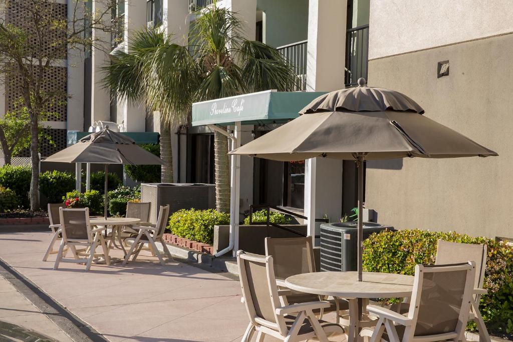 a group of tables and chairs with umbrellas at Grande Shores in Myrtle Beach