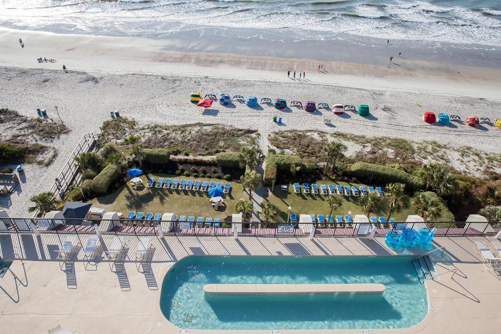 an aerial view of a beach with a pool and chairs at Grande Shores in Myrtle Beach
