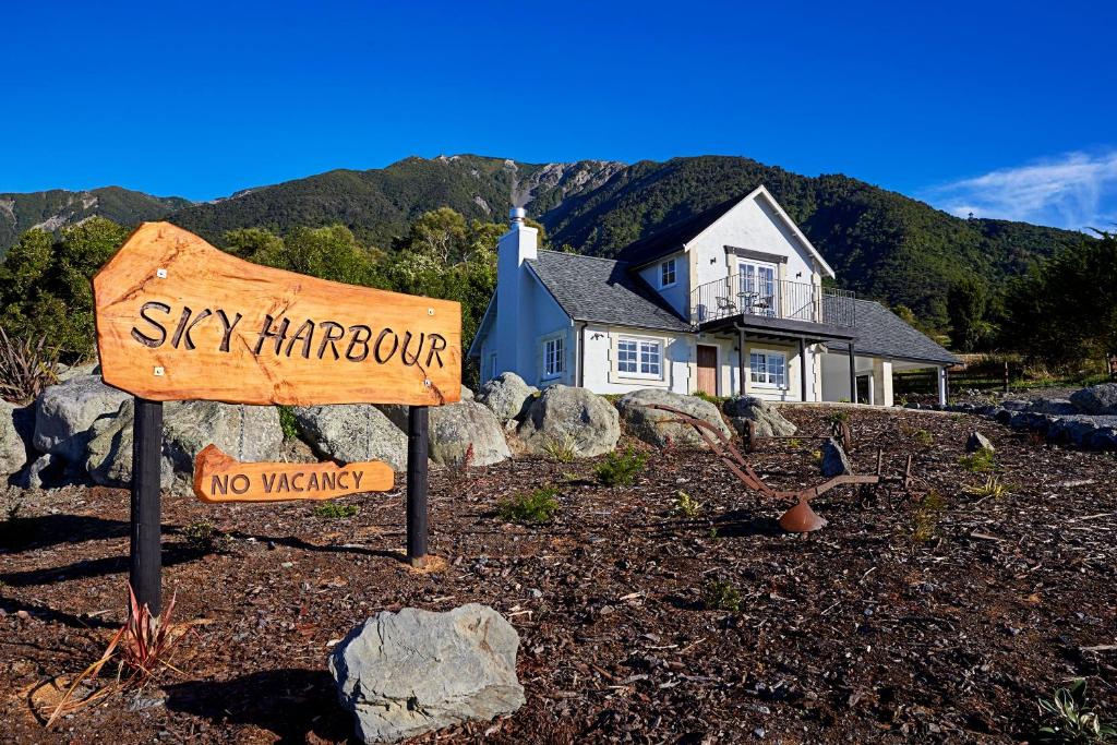 a sign in front of a house with a no walking sign at Sky Harbour in Kaikoura