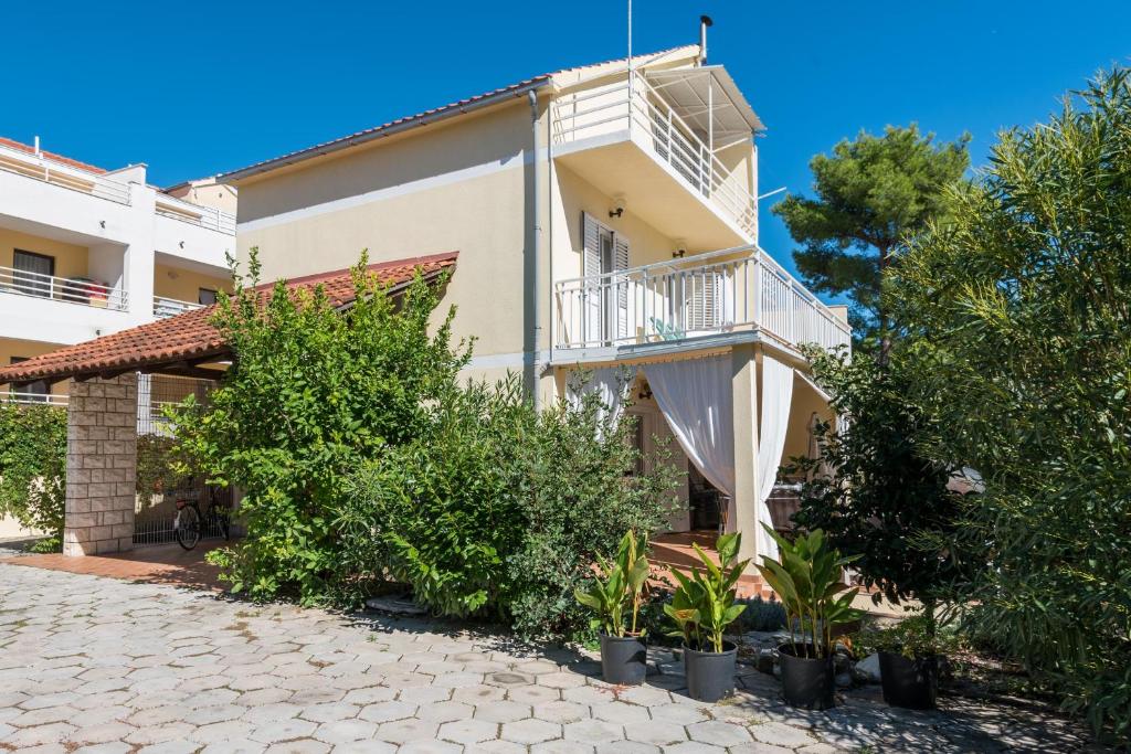 an apartment building with a balcony and plants at Holiday Home Jana in Orebić