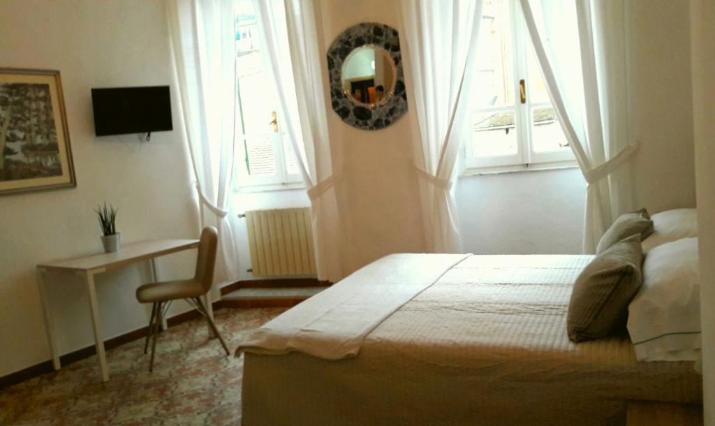 Postel nebo postele na pokoji v ubytování Taverna del Capitano Rooms