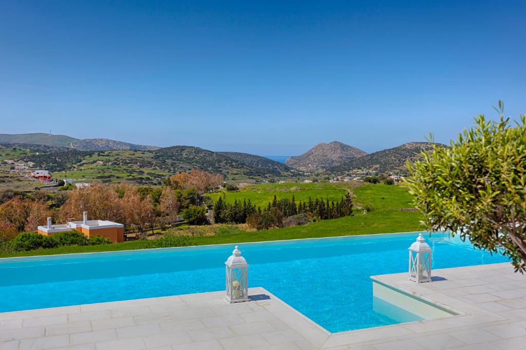 a swimming pool with a view of the mountains at Villa Casa Del Sol Syros in Parakopí