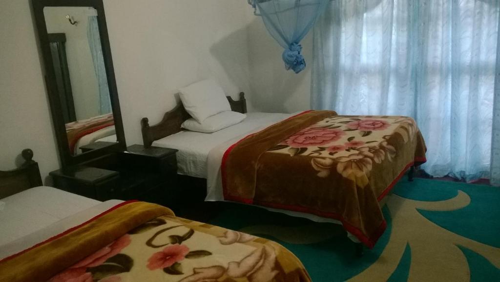 Postel nebo postele na pokoji v ubytování Srihelyes Inn