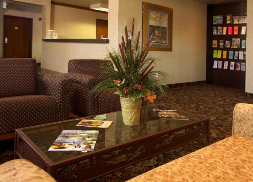a lobby with a table with a potted plant on it at Crivitz Lodge in Crivitz