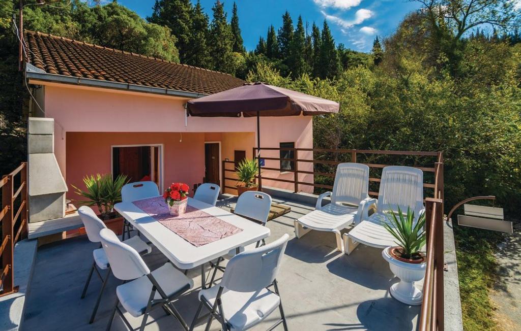 a patio with chairs and a table and an umbrella at Holiday Home Paul in Blace
