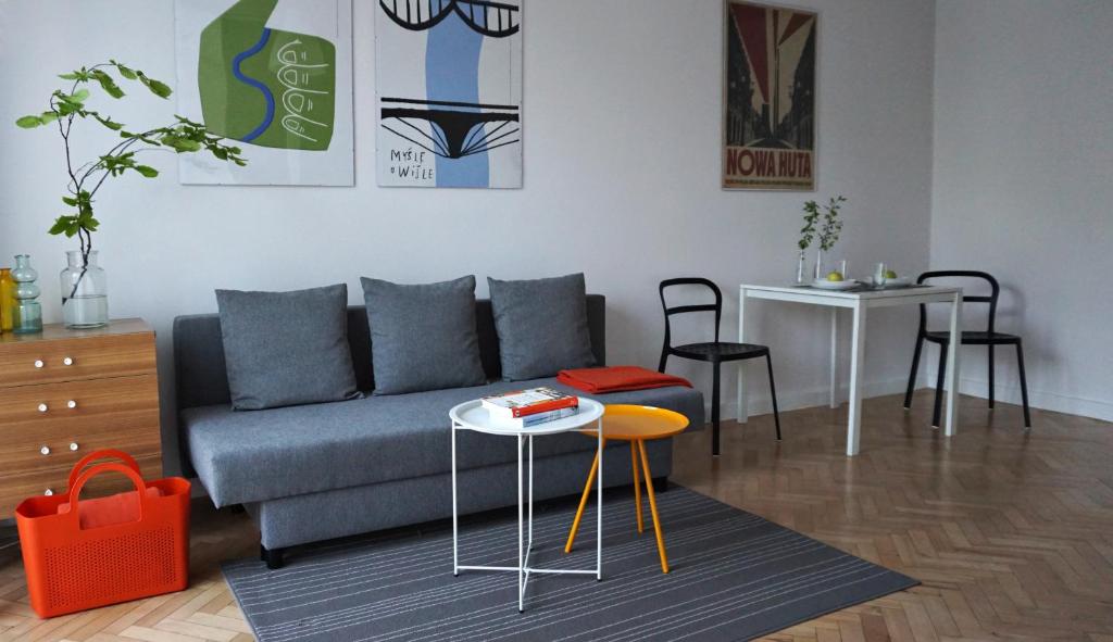 a living room with a couch and a table at Lovely Jubbly Apartment in Kraków