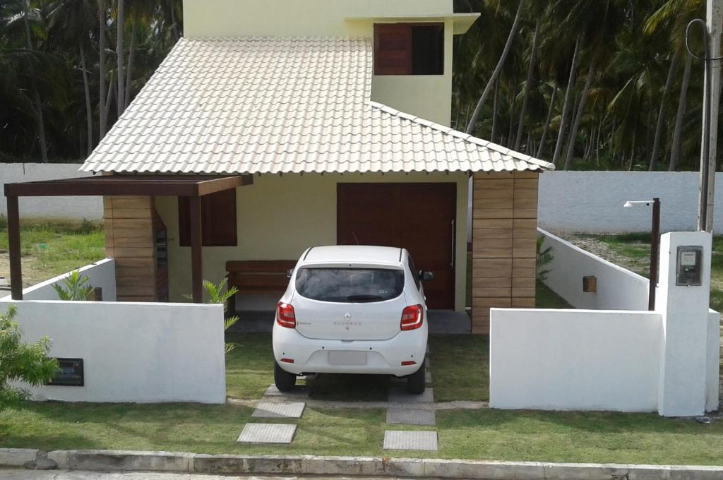 a white car parked in front of a house at Casa Recanto Gama in Pôrto de Pedras