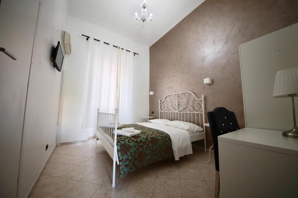 Postel nebo postele na pokoji v ubytování Hotel Pisa