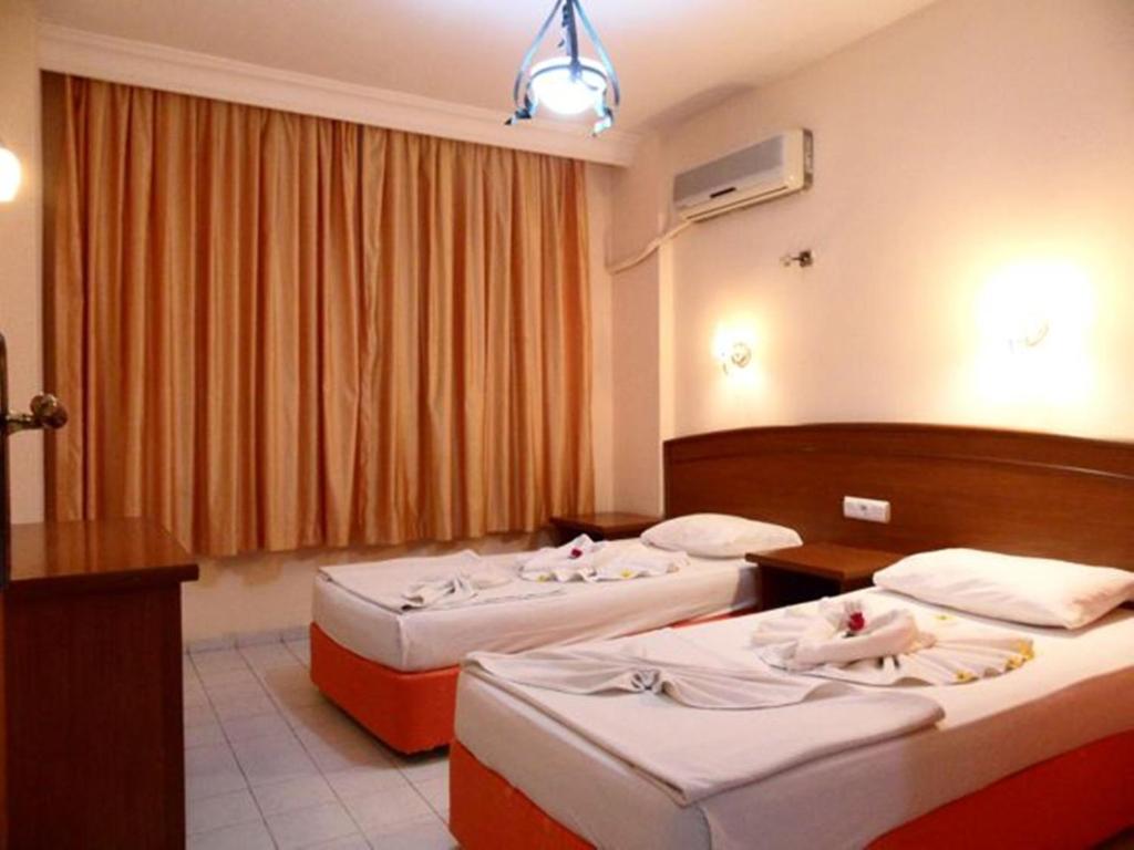 Postel nebo postele na pokoji v ubytování Baronessa Apart Hotel