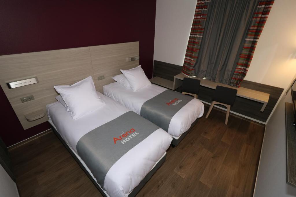 Postel nebo postele na pokoji v ubytování Hotel Arena Toulouse