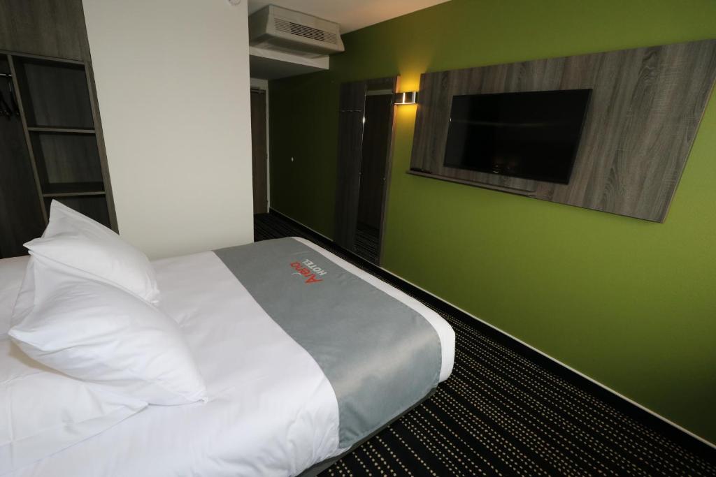 Postel nebo postele na pokoji v ubytování Hotel Arena Toulouse