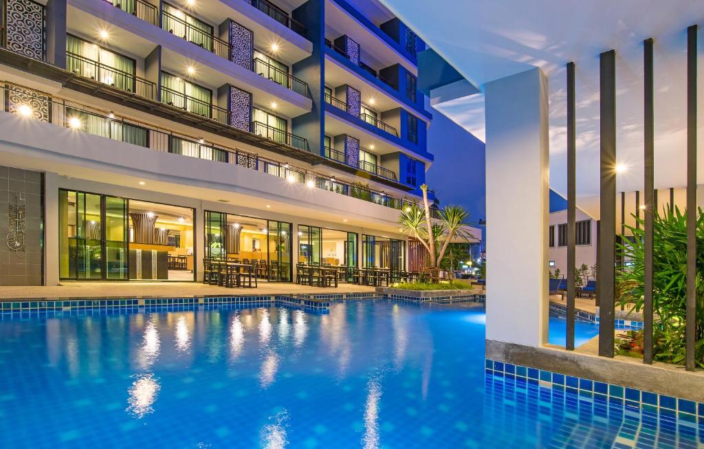 an image of a hotel swimming pool at night at AVA SEA Resort Krabi, Ao Nang Beach in Ao Nang Beach