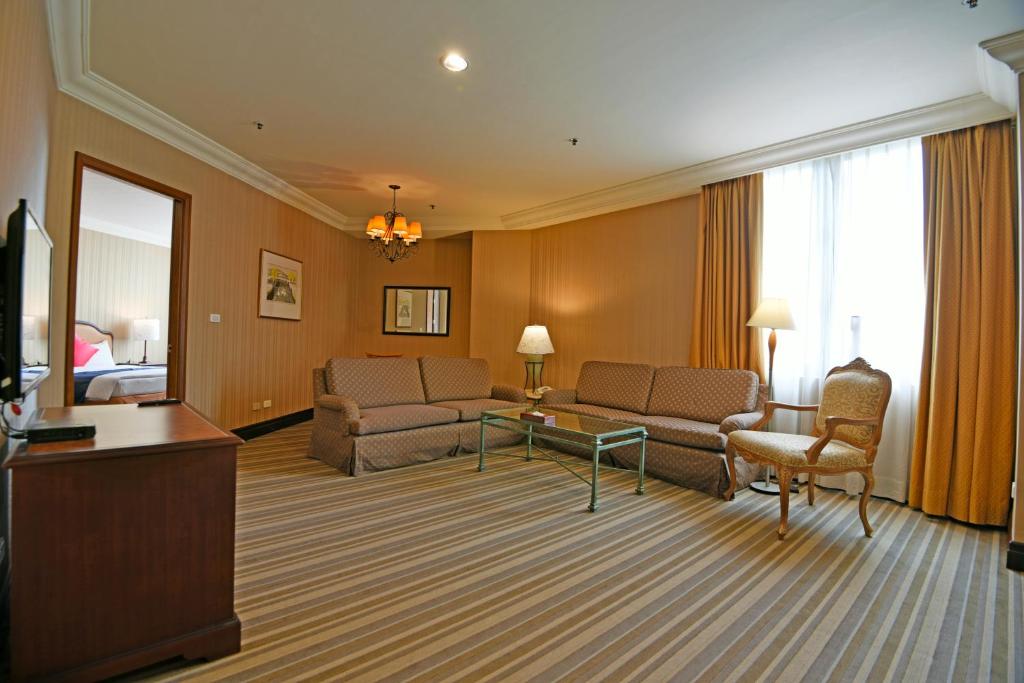 a hotel room with a couch and a table at Wei-Yat Grand Hotel in Anping