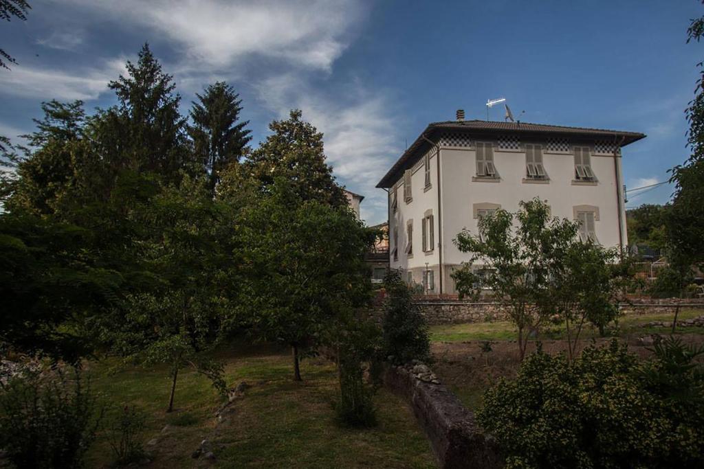 a large white house with trees in front of it at Villa Daura in Riccò del Golfo di Spezia