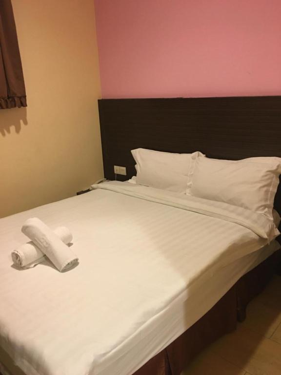 Postel nebo postele na pokoji v ubytování Lintas Plaza Hotel
