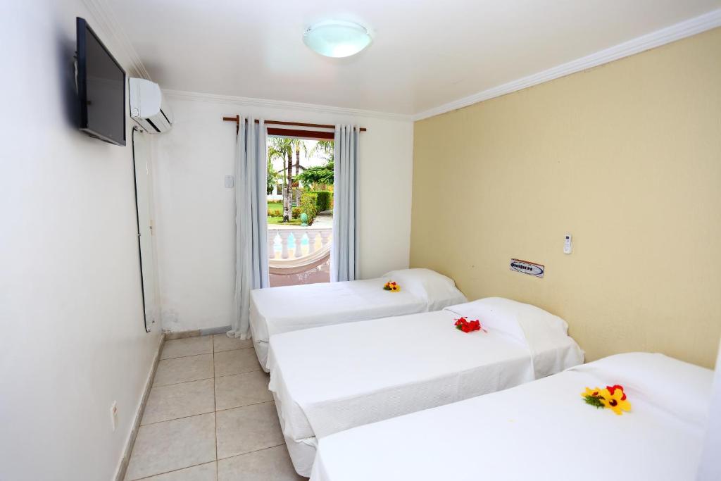 Postel nebo postele na pokoji v ubytování Benko´s Praia Hotel