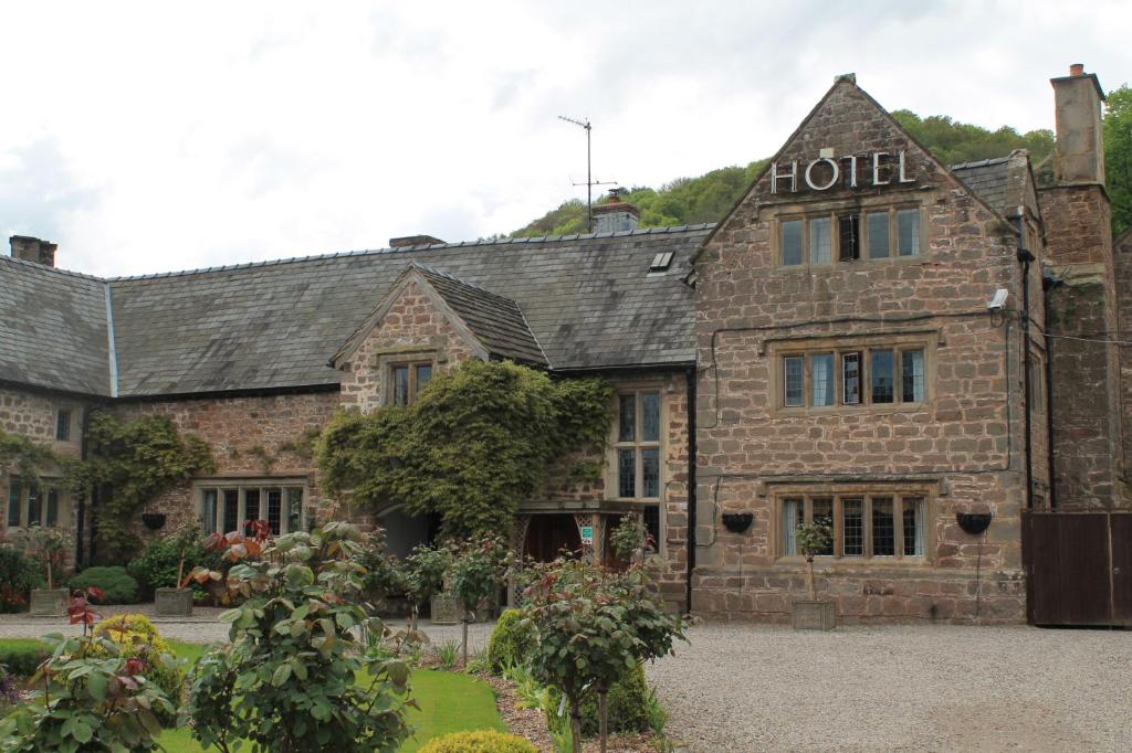 an old stone building with a hotel sign on it at Old Court Hotel & Apartments in Symonds Yat