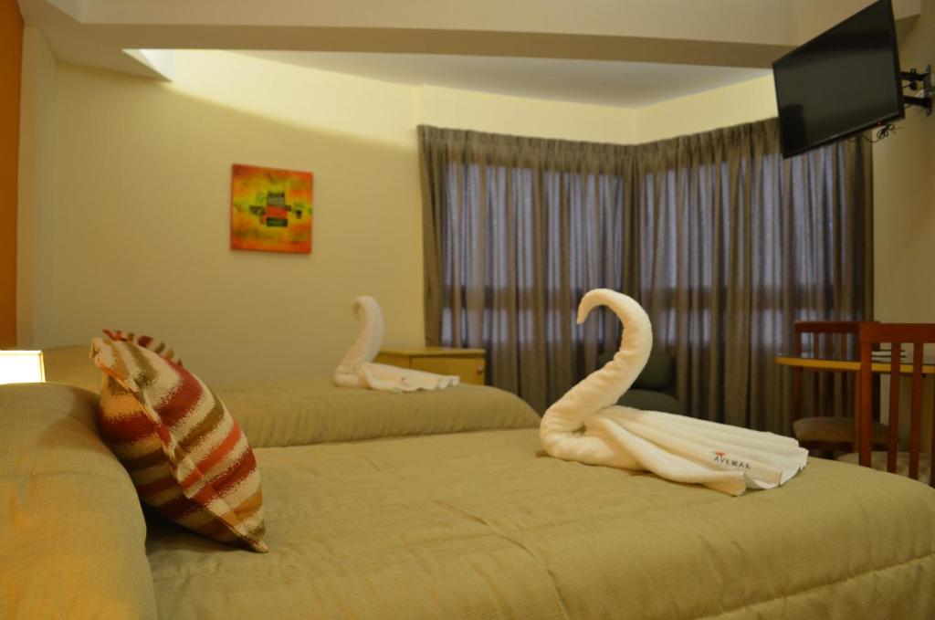Postel nebo postele na pokoji v ubytování AVEMAR Apart Hotel
