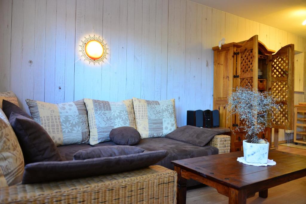 a living room with a couch and a table at Ferienwohnung Wegst in Schweigen-Rechtenbach