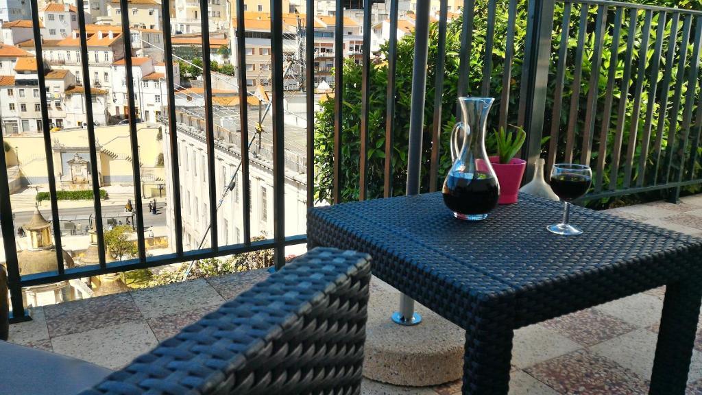 
a bottle of wine sitting on top of a bench at Apartment Rua Corpo de Deus in Coimbra in Coimbra
