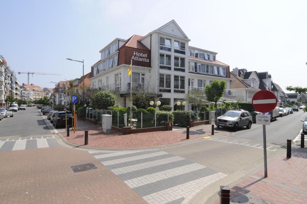 a city street with a building and a stop sign at Hotel Atlanta Knokke in Knokke-Heist